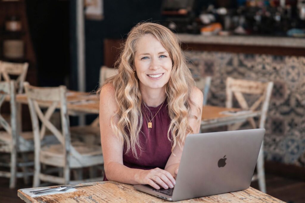 Nicole Saunders WITHIN founder with laptop
